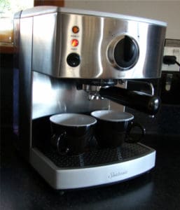 Place Portafilter in Machine with your cups underneath.